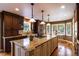 Kitchen with granite countertops, a large island with pendant lighting, and wood floors at 9 Roder Gate Ln, Castle Pines, CO 80108