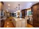 Open concept kitchen with a large island, stainless steel appliances, and hardwood floors at 9 Roder Gate Ln, Castle Pines, CO 80108