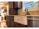 Close-up of a kitchen sink with granite countertops and custom wood cabinets at 9 Roder Gate Ln, Castle Pines, CO 80108