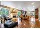 Open concept living room and kitchen featuring hardwood floors, a fireplace, and natural light at 9 Roder Gate Ln, Castle Pines, CO 80108