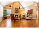 Comfortable living room with hardwood flooring, fireplace, plantation shutters, and elegant décor at 9 Roder Gate Ln, Castle Pines, CO 80108