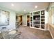 Cozy living room with custom built-in shelving unit, recessed lighting, and neutral paint at 9 Roder Gate Ln, Castle Pines, CO 80108