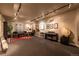 Basement living room features a large area rug, track lighting, and a variety of music memorabilia at 9 Roder Gate Ln, Castle Pines, CO 80108