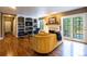 Living room with custom bookshelves, a fireplace, hardwood floors, and ample lighting at 9 Roder Gate Ln, Castle Pines, CO 80108
