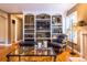 Living room with custom bookshelves, hardwood floors, and ample lighting at 9 Roder Gate Ln, Castle Pines, CO 80108