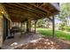 Outdoor patio with a stone pillar, wooden beams and backyard views of the landscaped backyard at 9 Roder Gate Ln, Castle Pines, CO 80108