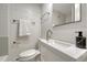 Modern bathroom featuring a sleek sink, toilet, towel rack, and toiletries at 1355 Gaylord St # 6, Denver, CO 80206