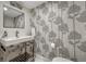 Stylish half bathroom featuring unique tree-themed wallpaper, contemporary fixtures, and a sleek sink design at 1355 Gaylord St # 6, Denver, CO 80206