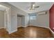 Bright bedroom featuring hardwood floors, a ceiling fan, an air conditioner, and plenty of natural light at 1355 Gaylord St # 6, Denver, CO 80206