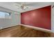 Comfortable bedroom with wood floors, a ceiling fan, and mini-split air conditioner for personalized climate control at 1355 Gaylord St # 6, Denver, CO 80206
