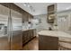 Modern kitchen with stainless steel appliances, breakfast bar, and ample cabinet space at 1355 Gaylord St # 6, Denver, CO 80206