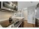 Modern kitchen features stainless appliances, an electric cooktop, and a seamless connection to the dining area at 1355 Gaylord St # 6, Denver, CO 80206