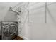 Functional laundry room equipped with a modern washer and dryer, and practical shelving at 1355 Gaylord St # 6, Denver, CO 80206