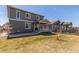 Backyard view of a home with a covered patio and a well-maintained lawn at 22921 E Union Ave, Aurora, CO 80015