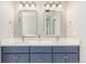 Stylish bathroom with a double sink vanity, framed mirrors, and modern lighting at 22921 E Union Ave, Aurora, CO 80015