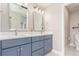 Elegant bathroom with a double sink vanity, sleek mirrors, and contemporary fixtures at 22921 E Union Ave, Aurora, CO 80015