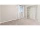 Bedroom featuring neutral carpet, a large window, and a walk-in closet with built-in shelving at 22921 E Union Ave, Aurora, CO 80015