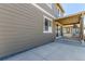 Home's exterior featuring a covered patio with sliding glass doors and neutral siding at 22921 E Union Ave, Aurora, CO 80015