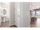 Hallway view with white door adjacent to a half bathroom and open concept kitchen island at 22921 E Union Ave, Aurora, CO 80015