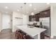 Well-lit kitchen with stainless steel appliances, a large island with seating, and ample cabinet space at 22921 E Union Ave, Aurora, CO 80015