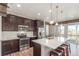 Modern kitchen with stainless steel appliances, granite countertops, and a breakfast bar with seating at 22921 E Union Ave, Aurora, CO 80015