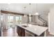 Modern kitchen open to the living area, featuring an island and access to the outdoor patio at 22921 E Union Ave, Aurora, CO 80015