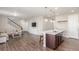Spacious living room with a built-in entertainment center and an open view to the kitchen island at 22921 E Union Ave, Aurora, CO 80015