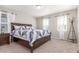 Well-lit main bedroom with neutral carpeting, large windows, and stylish furnishings at 22921 E Union Ave, Aurora, CO 80015