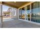 Covered patio featuring sliding glass doors, concrete flooring, and outdoor living space at 22921 E Union Ave, Aurora, CO 80015