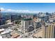 A vibrant aerial view showcasing the community's architectural design against the backdrop of Denver's skyline and mountains at 975 N Lincoln St # 3H, Denver, CO 80203