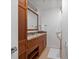Bathroom featuring a wooden vanity, mirror, and towel racks at 975 N Lincoln St # 3H, Denver, CO 80203