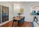 Cozy dining area with stylish green chairs, wood floors, and modern lighting fixture at 975 N Lincoln St # 3H, Denver, CO 80203