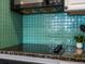 Modern kitchen cooktop with bright backsplash and stylish countertop at 975 N Lincoln St # 3H, Denver, CO 80203