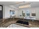 Open kitchen with granite countertops and a view into the cozy living room, perfect for entertaining guests at 975 N Lincoln St # 3H, Denver, CO 80203