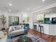 Inviting living room seamlessly connects to the kitchen, featuring modern furnishings and hardwood floors at 975 N Lincoln St # 3H, Denver, CO 80203