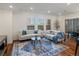 Inviting living room featuring a plush rug, comfortable seating, and an abundance of natural light at 975 N Lincoln St # 3H, Denver, CO 80203