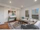 Bright living room featuring contemporary decor and hardwood floors at 975 N Lincoln St # 3H, Denver, CO 80203