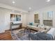 Bright living room with large windows, wood floors, a stylish area rug, and comfortable seating at 975 N Lincoln St # 3H, Denver, CO 80203