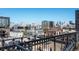 Breathtaking rooftop vista, capturing the city skyline, surrounding buildings, and distant mountain peaks from behind decorative railings at 975 N Lincoln St # 3H, Denver, CO 80203