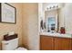 Charming powder room with patterned wallpaper, decorative accents, and vanity at 178 Blue Bonnet Dr, Brighton, CO 80601