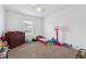 Spacious bedroom with a bed, a dresser, and carpeted floors, decorated with toys and play equipment at 178 Blue Bonnet Dr, Brighton, CO 80601