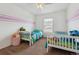 Cozy bedroom with two beds, neutral carpet and playful décor creating a welcoming space at 178 Blue Bonnet Dr, Brighton, CO 80601