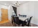 Elegant dining area with marble table, leather chairs, and modern chandelier at 178 Blue Bonnet Dr, Brighton, CO 80601