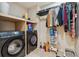 Functional laundry room featuring a washer, dryer, shelving, and space for laundry essentials at 178 Blue Bonnet Dr, Brighton, CO 80601