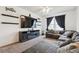 Cozy living area with fireplace, mounted TV, and comfortable sectional seating at 178 Blue Bonnet Dr, Brighton, CO 80601