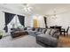Bright living room features plush sectional sofa, large windows, and stylish lighting at 178 Blue Bonnet Dr, Brighton, CO 80601