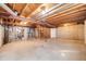 Unfinished basement with exposed wooden beams and concrete foundation at 12717 E Cornell Ave, Aurora, CO 80014