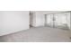Spacious bedroom with mirrored closet doors and neutral carpet flooring at 12717 E Cornell Ave, Aurora, CO 80014