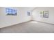 Bright bedroom features three windows, neutral carpet, and white walls at 12717 E Cornell Ave, Aurora, CO 80014