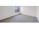 Bedroom features a large window and neutral colored carpeting at 12717 E Cornell Ave, Aurora, CO 80014